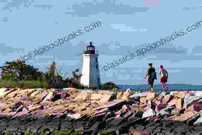 A Group Of People Walking Along A Beach Towards A Lighthouse On A Sunny Day. Itty Bitty Kitty Guide To Lighthouses Of New Hampshire